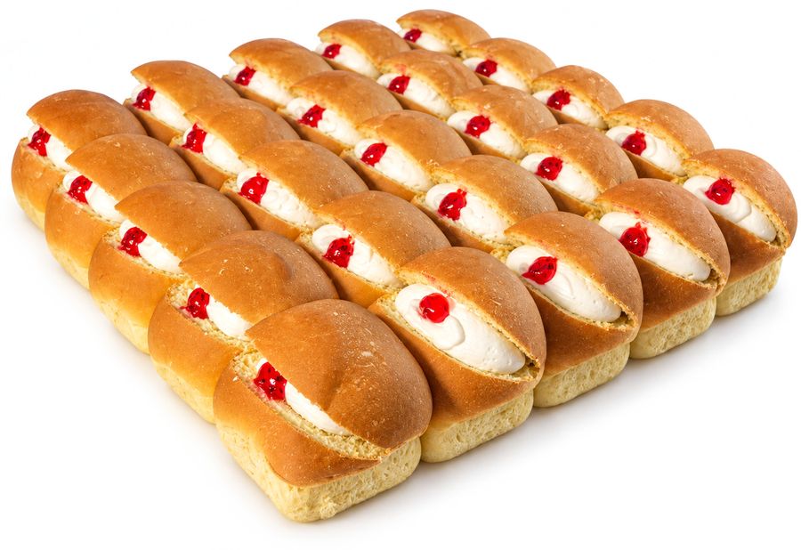 A tray of Cowley creamed buns, each split and filled with cream and jam.