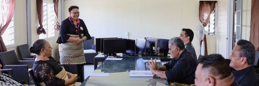 The handover meeting, with donated monitors lined up on the table.