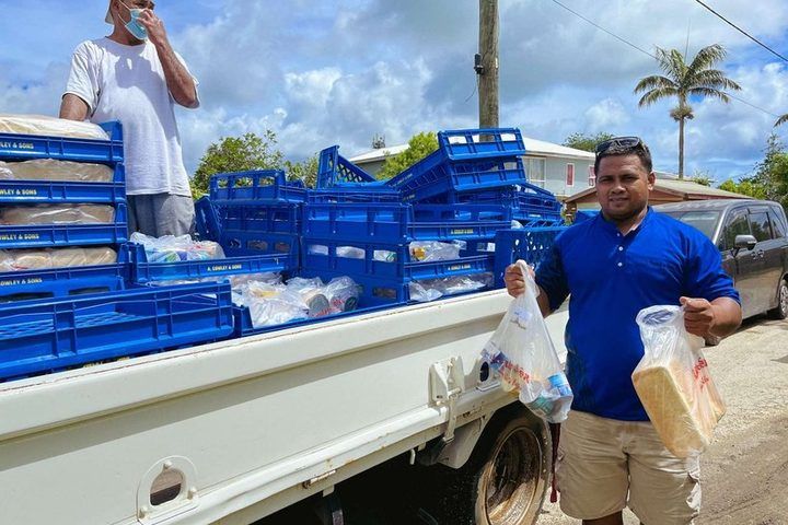 A truck loaded with crates of packed food parcels ready for delivery.