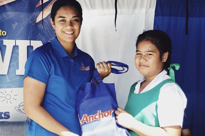 A student receiving her Anchor back-to-school pack.