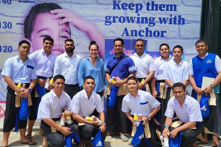 Tupou College students with their school packs and Anchor drinks.
