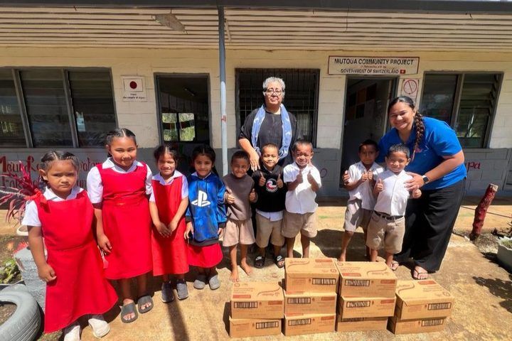 Students at Niutoua with their cartons of milk.