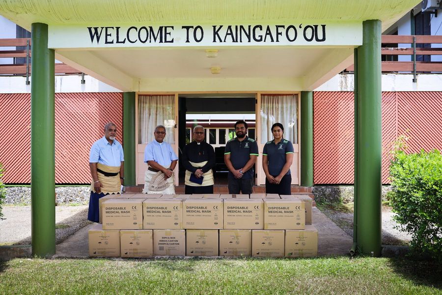 The handover at Kaingafo’ou, cartons of masks laid out at the entrance.