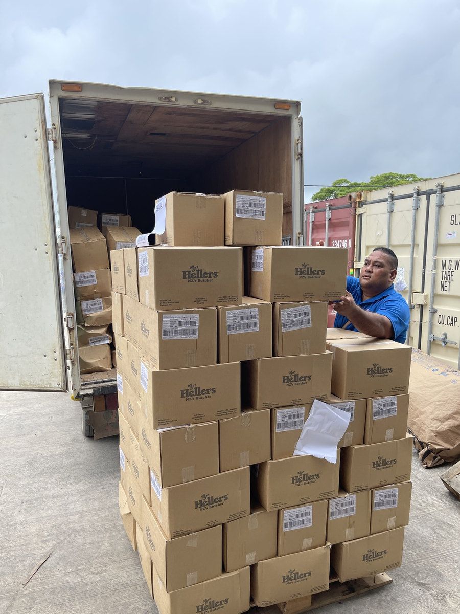 Cartons of Hellers stock being unloaded from the back of a delivery truck.