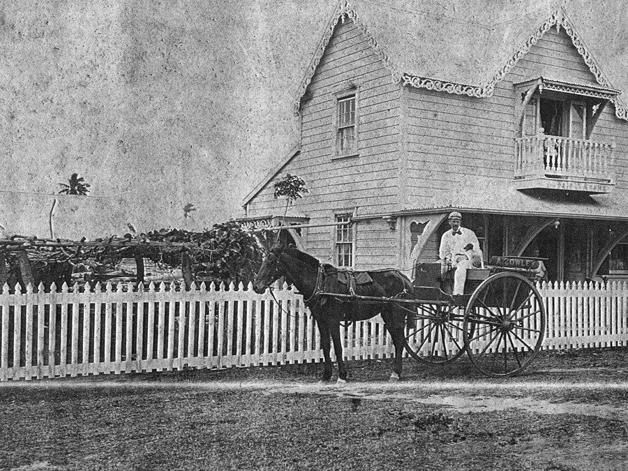 A horse and two-wheeled gig at the gate, with A. Cowley painted on the side panel.