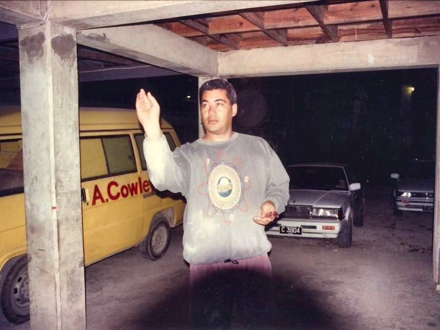 A yellow delivery van lettered A. Cowley in red, parked under a carport.