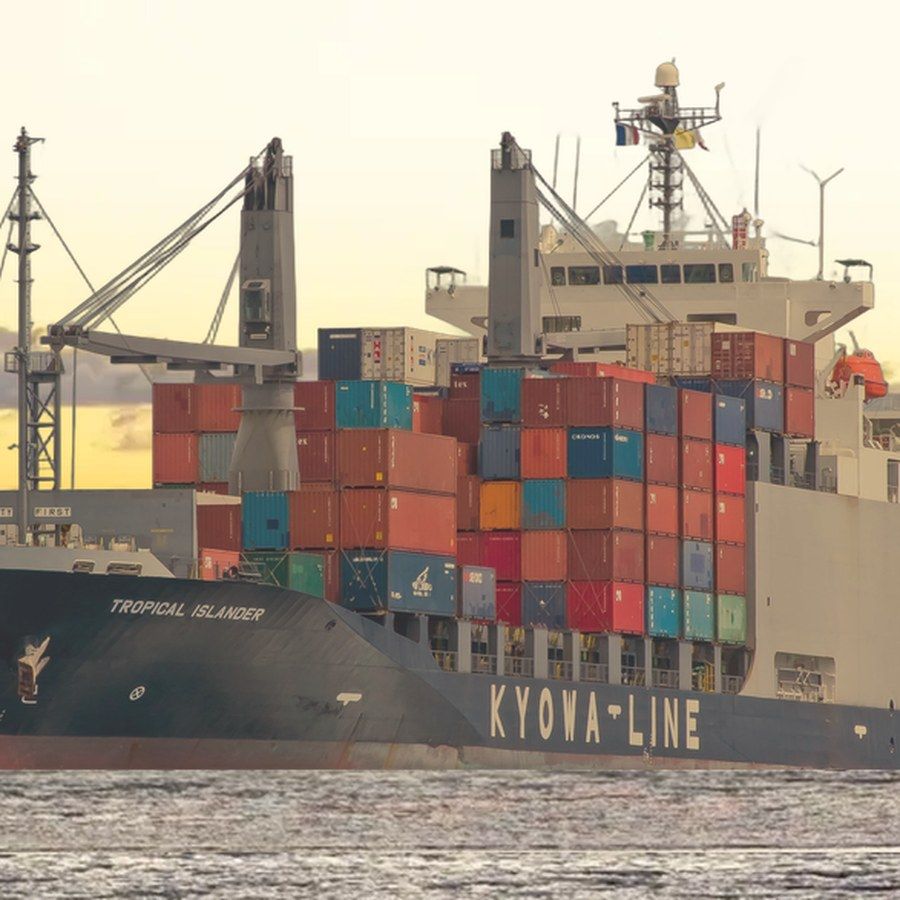 The Kyowa Line container ship Tropical Islander off Tonga, stacked with containers.