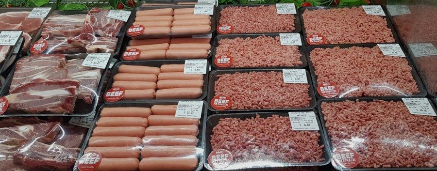 Beef sausages and trays of premium beef mince on display.