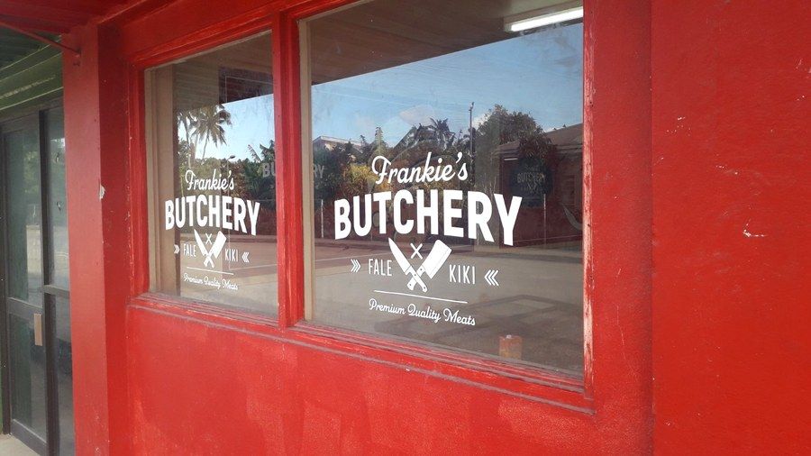 The red shopfront, its window lettered Frankie's Butchery — Fale Kiki — Premium Quality Meats.