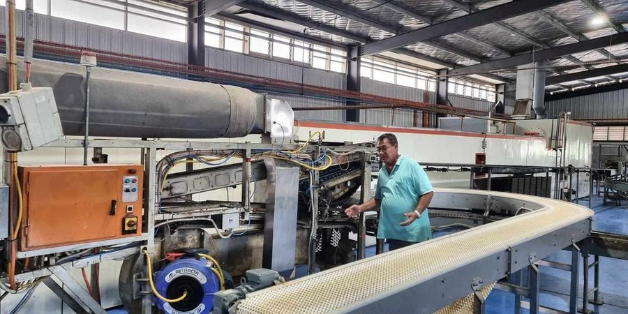 The cooling conveyor curving away from the depanner, running the length of the building.