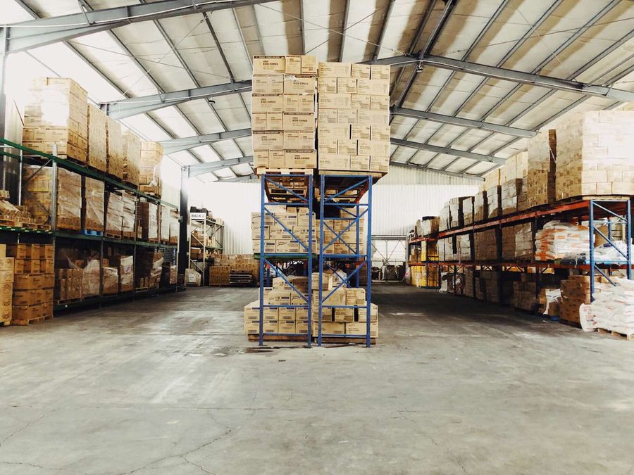 The ACS Wholesale racking hall, pallets stacked to the roof either side of the aisle.
