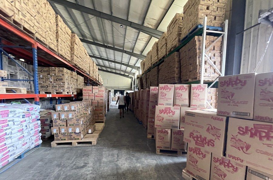 A stocked aisle running the length of the warehouse.